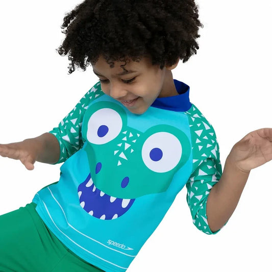 Green Speedo Corey Croc swim top and shorts set for kids, featuring a rash guard and swim shorts with crocodile design.