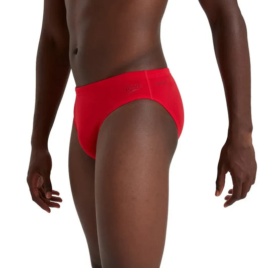 Red Speedo men's Eco Endurance+ 7cm brief, swimwear with a snug fit and durable fabric, shown on a plain background.