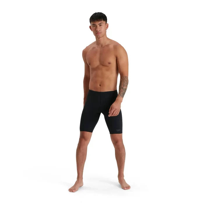 Speedo men's Eco Endurance+ jammer swimsuit, close-up of navy blue swimwear with Speedo logo for competitive swimming.