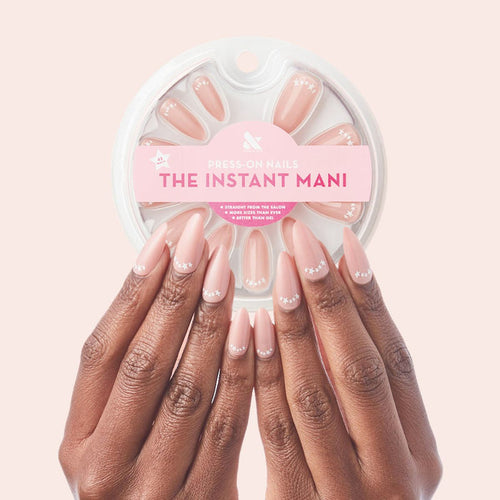 Star Halfmoon - Press-On | Long | Almond showing hands with long almond press-on nails in soft nude with white star halfmoon design manicure