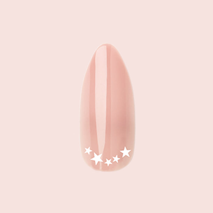 Star Halfmoon - Press-On | Long | Almond showing single long almond press-on nail in nude with white star halfmoon design manicure