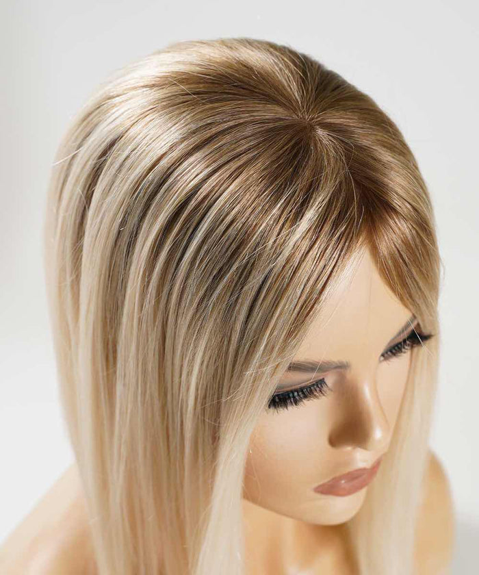 The Perfect Locks Straight Human Hair Crown Topper with rooted ash blonde color, long straight hair, smooth skin, defined brows, closed lips, and long eyelashes.#color_rooted-ash-blonde-(8/60)
