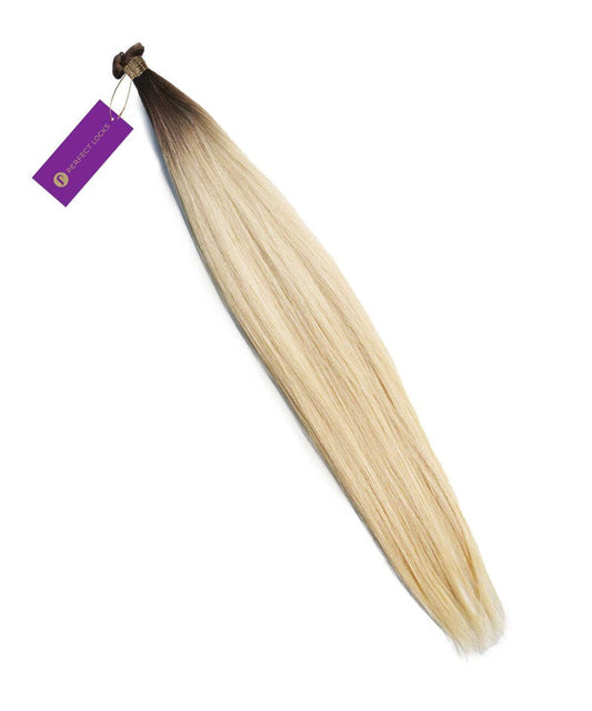 A bundle of Perfect Locks Straight Hybrid Weft Hair Extensions in Natural Black , secured with a band and a purple tag.#color_champagne-highlights-(18A/60)