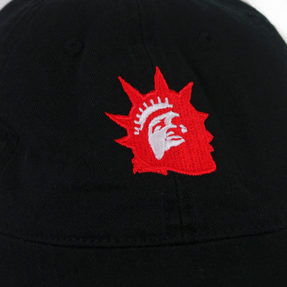 A close-up of a black fabric surface with an embroidered red and white Liberty Red Logo, resembling the Statue of Liberty, by Trophy Eyes—perfect for any Black Dad Hat.