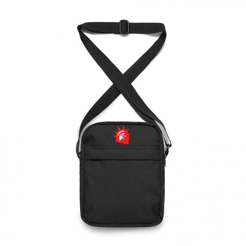 Trophy Eyes black shoulder bag with an adjustable strap, featuring a small red Statue of Liberty head graphic on the upper front. The bag has a simple, minimalist design.