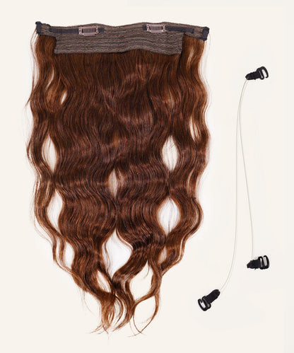 Perfect Locks Wavy Perfect Crown Hair Extensions in Platinum Blonde  beside two clear elastic bands with black clasps on white.#color_chocolate-brown-(3)