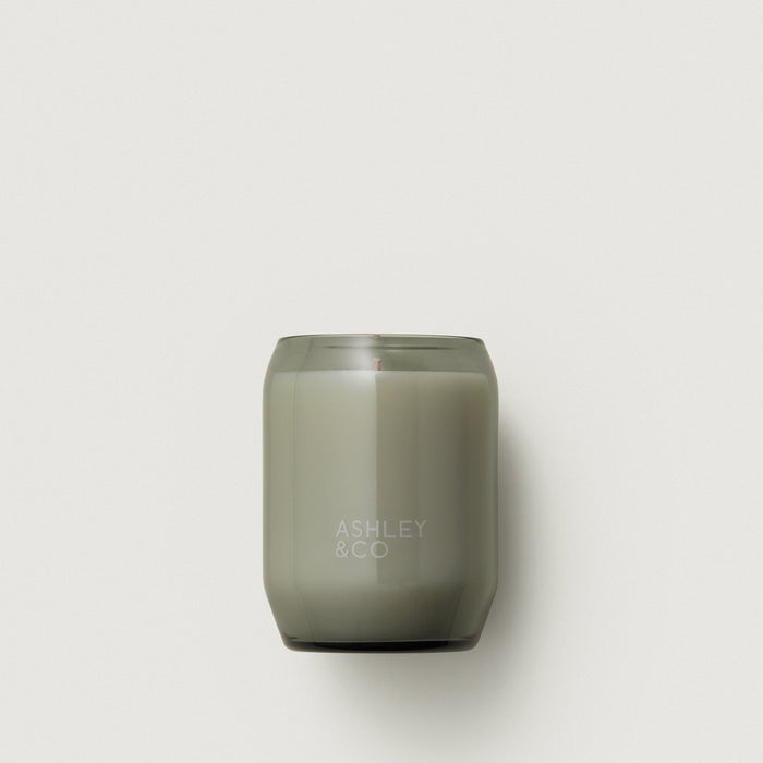 Smoky olive waxed perfume candle in a frosted glass jar